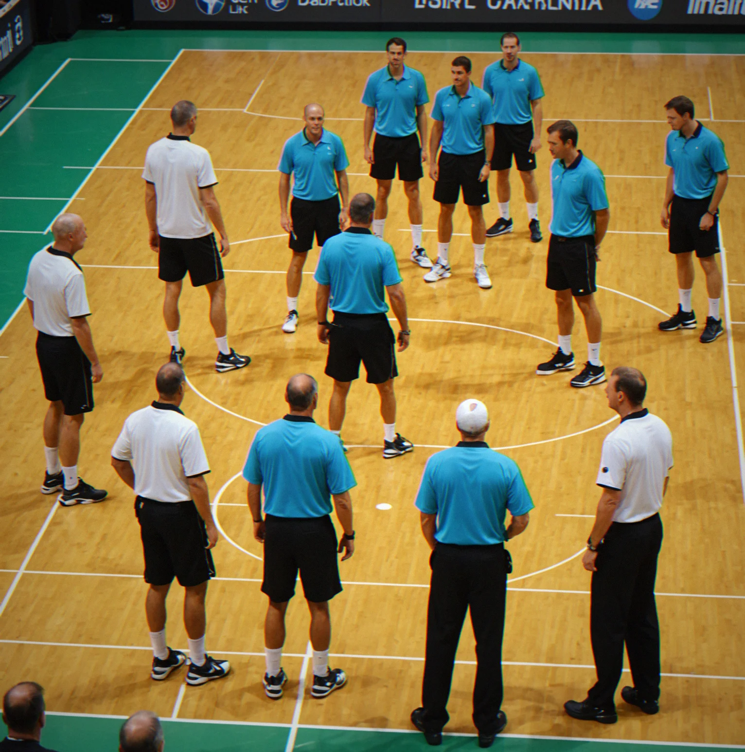 Ref making a call while players stand by waiting to get back to it